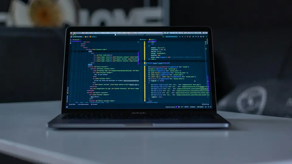 A laptop displaying a code editor in a developer workspace; not a screenshot of a named coding agent.