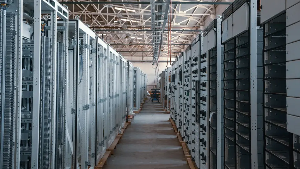 An aisle between server racks, representing the infrastructure used by data platforms.
