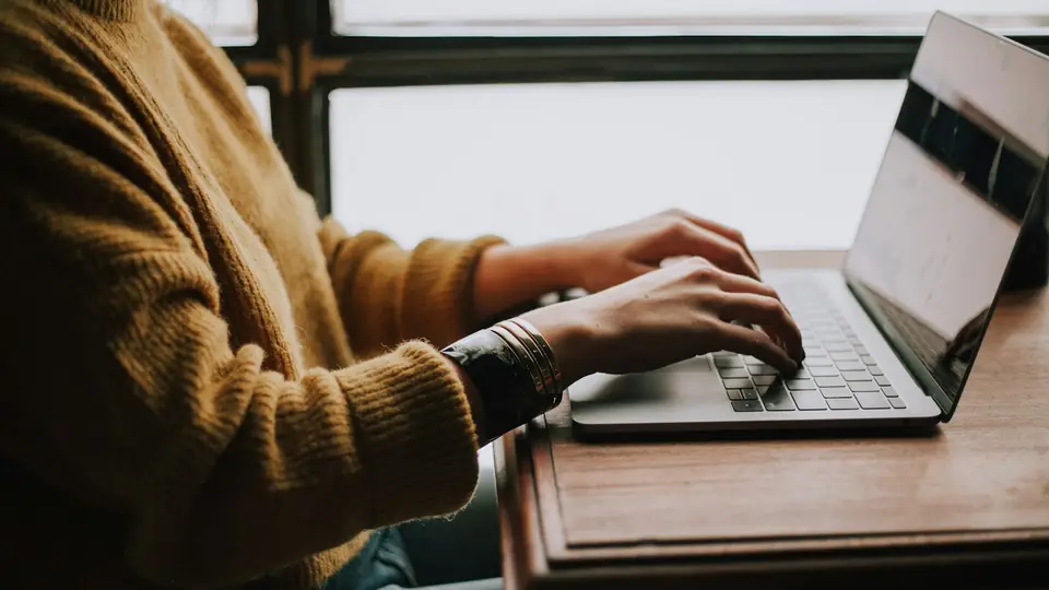 Hands typing on a laptop, contextual photography for an article about business data analysis.